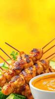 Delicious chicken skewers with peanut sauce. Grilled meat, fresh garnish, and food background. For restaurants photo
