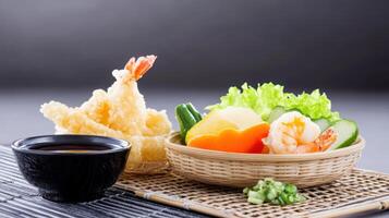 Delicious shrimp tempura with salad and dipping sauce served on a tray. Possible food ad photo