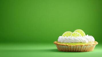 Dessert Lime Pie Close-up of tasty pie topped with whipped cream and limes on solid green background photo