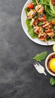 Grilled Chicken Skewers on salad served with lemon and sauce. Food photography for blog photo