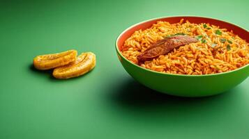 Jollof rice with plantain in a bowl against a green background, meal, food styling, possible use for cooking photo