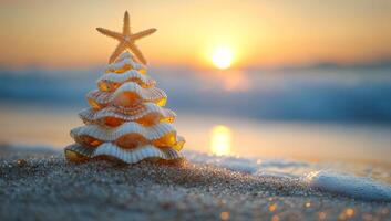 Decorative shell tree at sunset on beach. A creative arrangement of seashells shaped like a tree sits on the sand as the sun sets over the ocean. photo