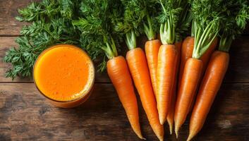 Fresh carrot juice and carrots. Carrots and a glass of bright orange juice on a wooden table highlight their vibrant colors and freshness. photo