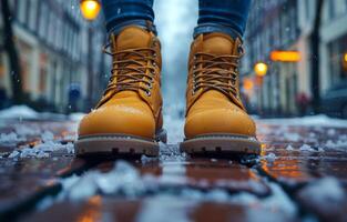 Bright yellow boots on a snowy street. Bright yellow boots stand out against a snowy street during winter, creating a cozy, adventurous vibe. photo