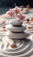 Orchids on stacked stones in sand. Three smooth stones are stacked with delicate orchids, surrounded by gentle sand patterns. photo