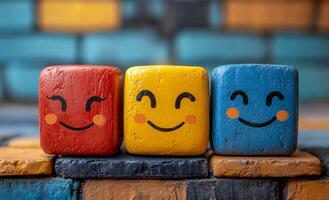 Smiley face blocks on display. Three colorful wooden blocks photo