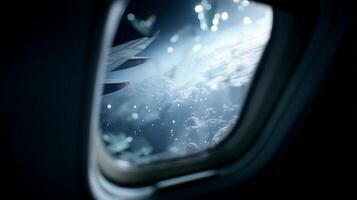 View of fluffy clouds and airplane wing against a serene blue sky from a window seat during flight photo