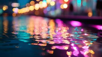 Colorful reflections dance on calm water surface during evening in a vibrant urban setting photo