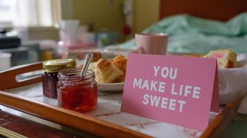 Breakfast tray with pastries and a heartfelt message in a cozy bedroom setting photo