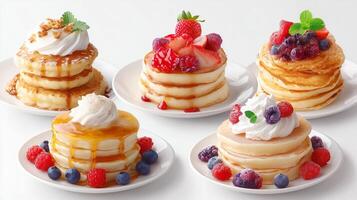 Pancake stack variety with fresh fruits and whipped cream served on white plates during a bright breakfast setting photo