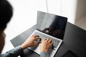 Engineer working with laptop Hands typing keyboard. Professional investor working new start up project. business planning in office. Technology business. photo