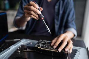 a engineer is working on a computer with a screwdriver photo