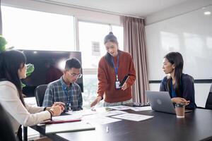Asian business people Application Designers presenting trending products report mobile application planning process development software design project ux Graphic designer photo