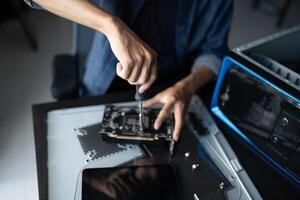 a person is working on a computer with a screwdriver photo