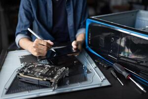a person working on a computer with a pen photo