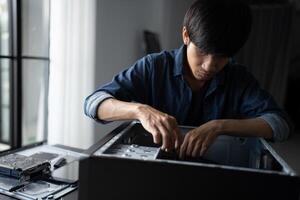 a man is working on a computer with a case photo