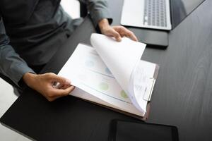 businessman with papers and laptop on table photo