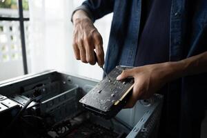 a man is fixing a computer with a motherboard photo