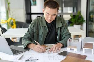 handsome man is working on a project at a desk photo
