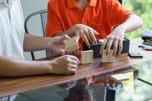 Asian father and son playing wood blocks playing wood blocks game building constructor from blocks with father photo