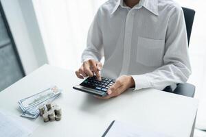 a man is using a calculator to calculate the amount of money he has photo