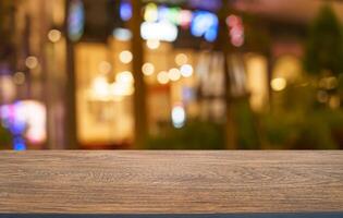 empty wooden table on blurred resterant background photo