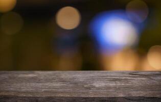 the wooden table top with blurred bokeh lights photo