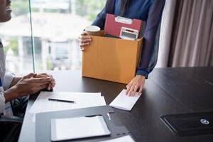 Quit Job asian business woman sending resignation letter and packing Stuff Resign carrying business cardboard box in office. Change of job or fired from company photo
