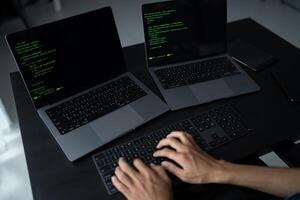 Asian man software engineer Working on Computer for writing program code IT Software Engineer finding errors tech support devops creating digital photo
