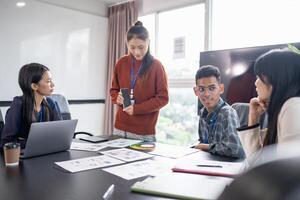 Asian businesswoman Application Designers presenting trending products report mobile application planning process development software design project ux Graphic designer photo