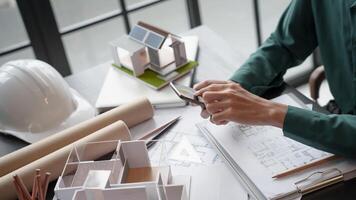 Architecture Man use smart phone for architectural Creative project business architecture ecosystem building construction Industrial engineering Design. photo