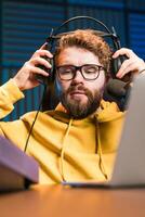 Young smiling male radio presenter banner talking into the microphone and reading news, information and communication concept. Podcast and internet streaming concept. photo
