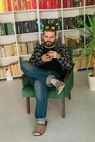 Attractive smiling hipster man relaxing at home. Gen Z and millennial photo