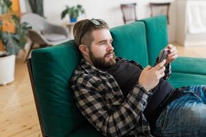 Young man surfing on social networking site using smartphone. Technologies photo