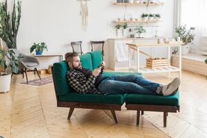 Young man surfing on social networking site using smartphone. Technologies and internet photo