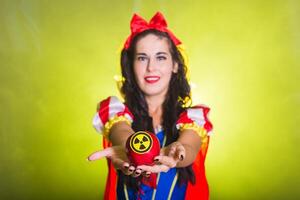 Fairy Woman wearing a fairy tale dress holding an apple with radiation symbol. Environmental problems concept, radioactive disaster as danger on nature. photo