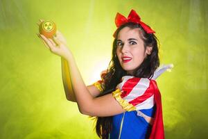 Crazy Woman dressed as fairytale character holds Radioactive atomic nuclear ionizing radiation danger warning symbol on apple. Nuclear and radiation measurement concept. photo