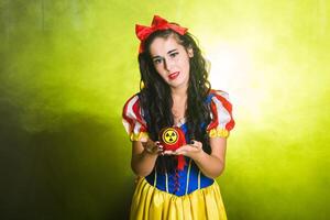 Sad Woman holding hazardous radioactive apple. Nuclear and radiation measurement concept. photo