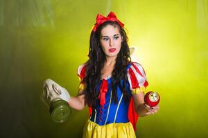 Woman dressed as fairytale character holds Radioactive atomic nuclear ionizing radiation danger warning symbol on apple. Nuclear and radiation photo