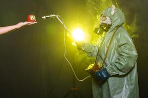 Radiation, pollution and danger concept - Men in protective clothing and a gas mask on a dark background photo