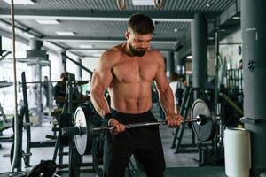 Muscular ,strong man is working out in the,, gym photo