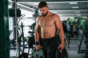 Muscula,r strong,, man is working out in the gym photo