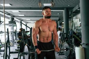 Muscular strong ,man ,is working out in the gym photo