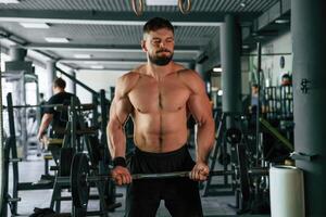 Muscular, strong ,,man is working out in the gym photo
