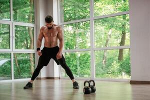 Focused at ,the exercise. Strong muscular man is working out in the gym photo