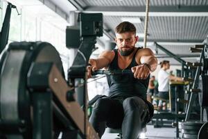 Exercise for stamina.. Strong muscular man is working out in the gym photo