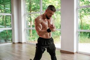 Strong muscular, man is working out in the gym photo
