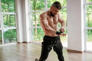 Strong,, muscular man is working out in the gym photo