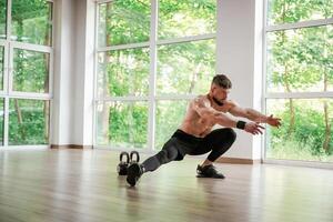Focused ,,at the exercise. Strong muscular man is working out in the gym photo
