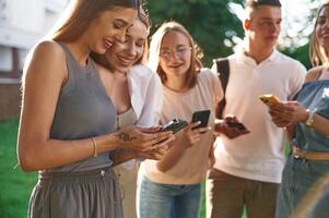 Cheerful, having fun. Group of students,, are ,outside together photo